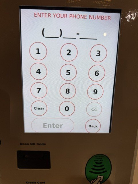 Parking kiosk keypad screen reading Enter Your Phone Number, with a numeric keypad and Enter, Clear and Back buttons